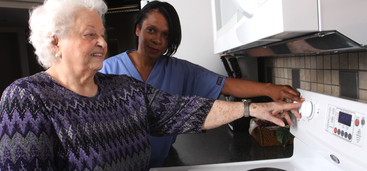 A rehabilitation professional demonstrates tactile markers on stove