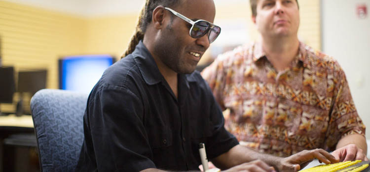 a blind man uses an accessible keyboard