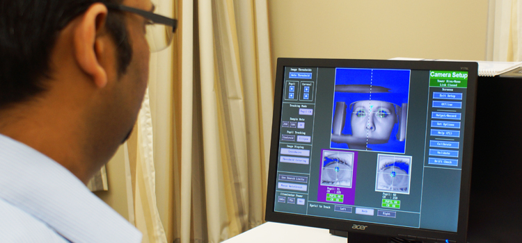 Researcher viewing a computer screen.