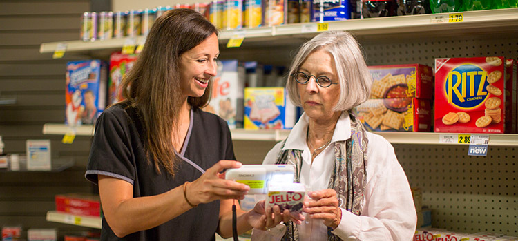 Woman and instructor grocery shopping