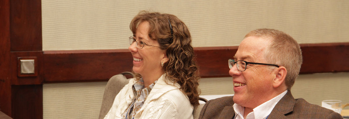 Two people smiling while attending a CE course