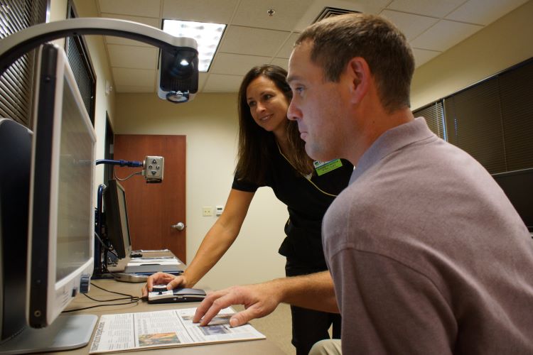 a clinical person is demonstrating a CCTV to another person