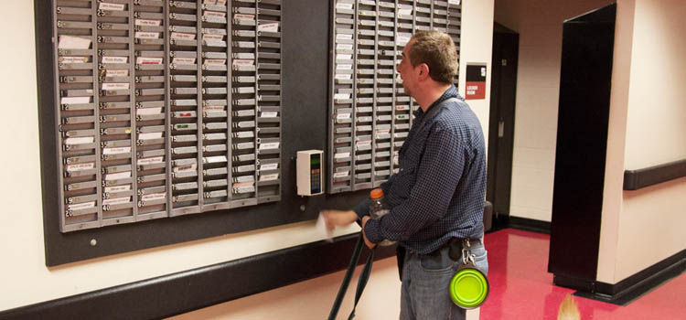 a man with a seeing eye guide dog is clocking into work