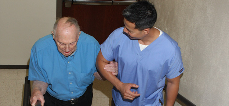 Elderly man being helped up steps