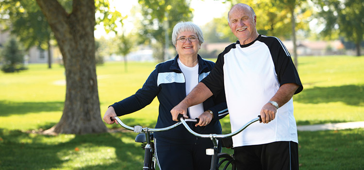 Elderly couple riding bikes