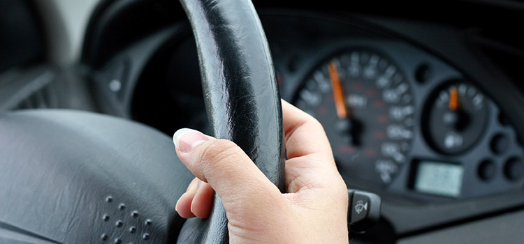 Woman clutching steering wheel